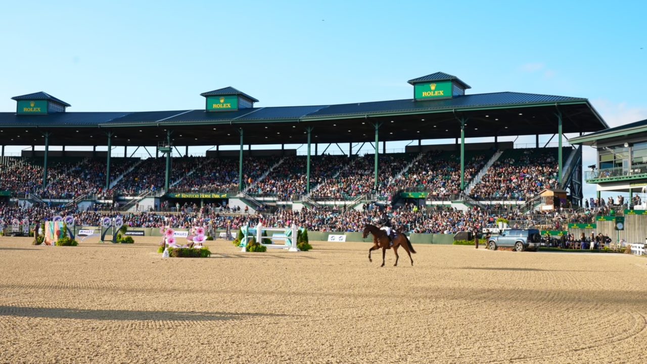 Packed grandstand at the Kentucky Horse Park in Lexington as a rider crosses the MLSJ arena